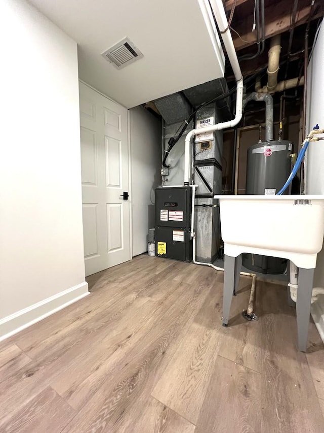 utilities featuring heating unit and gas water heater
