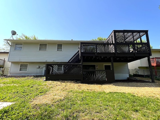 back of property with a wooden deck and a yard