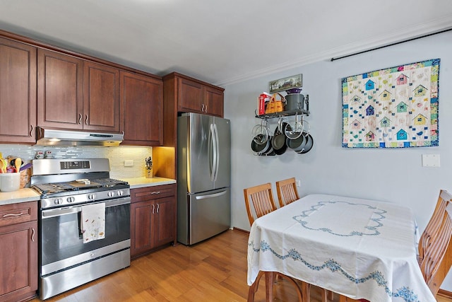 3101 Saint James St, Rolling Meadows, IL 60008 - kitchen with appliances with stainless steel finishes, under cabinet range hood, light countertops, decorative backsplash, and ornamental molding
