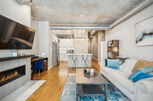 700 N Larrabee St Unit 905, Chicago, IL 60654 - living area featuring light wood finished floors and a tile fireplace