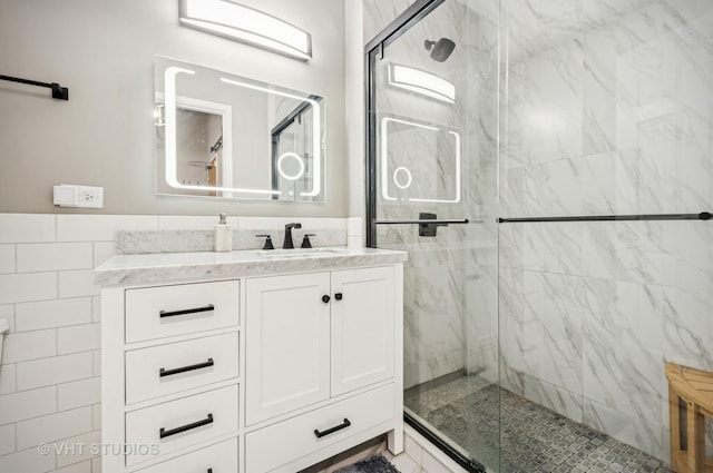 700 N Larrabee St Unit 905, Chicago, IL 60654 - full bath featuring a marble finish shower, vanity, and tile walls
