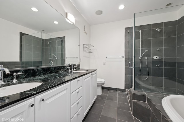 501 N Kingsbury St Unit G, Chicago, IL 60654 - bathroom with tile patterned floors, a stall shower, double vanity, recessed lighting, and tiled bath