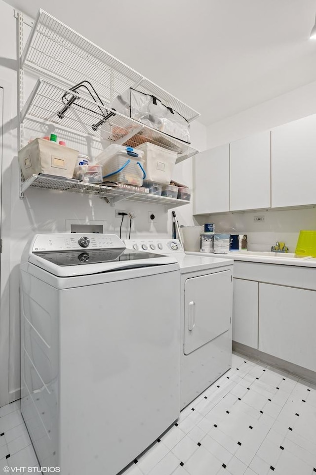 501 N Kingsbury St Unit G, Chicago, IL 60654 - washroom featuring independent washer and dryer, light floors, and cabinet space