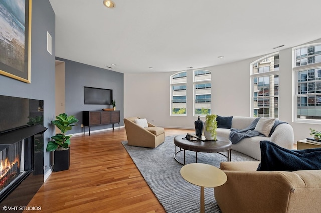 501 N Kingsbury St Unit G, Chicago, IL 60654 - living room featuring light wood finished floors, a glass covered fireplace, baseboards, and recessed lighting