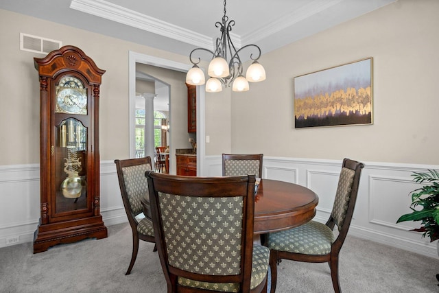 1021 Fire Fox Ct, Saint Charles, IL 60174 - dining area featuring a chandelier, ornate columns, carpet flooring, crown molding, and wainscoting