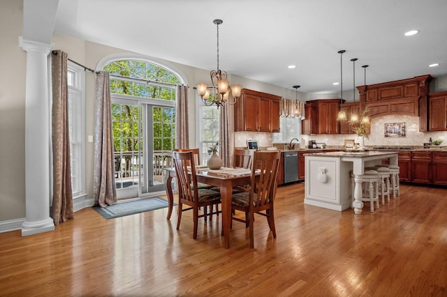1021 Fire Fox Ct, Saint Charles, IL 60174 - dining space featuring light wood-type flooring, a chandelier, healthy amount of natural light, recessed lighting, and decorative columns