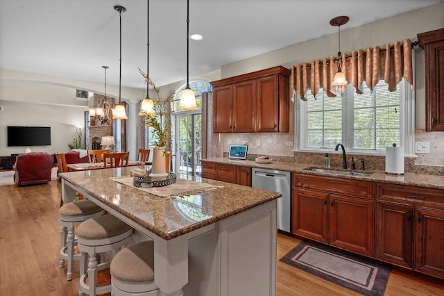 1021 Fire Fox Ct, Saint Charles, IL 60174 - kitchen with a sink, stainless steel dishwasher, a chandelier, and light stone countertops