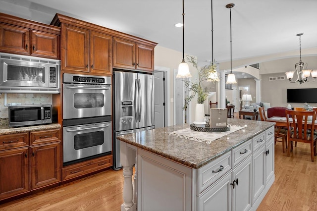1021 Fire Fox Ct, Saint Charles, IL 60174 - kitchen featuring stainless steel appliances, light wood finished floors, a chandelier, and backsplash