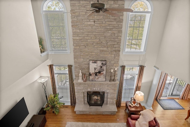 1021 Fire Fox Ct, Saint Charles, IL 60174 - living room with a high ceiling, ceiling fan, plenty of natural light, wood finished floors, and a fireplace