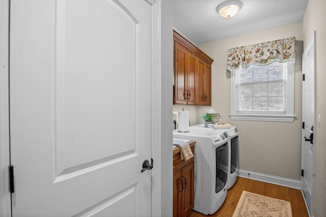 1021 Fire Fox Ct, Saint Charles, IL 60174 - clothes washing area featuring washer and clothes dryer, cabinet space, light wood-style floors, and baseboards