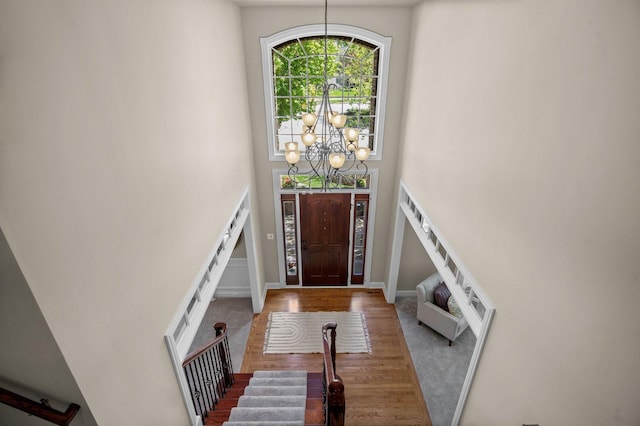 1021 Fire Fox Ct, Saint Charles, IL 60174 - foyer entrance featuring a chandelier, wood finished floors, a high ceiling, and baseboards