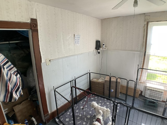 207 W Williams St, Dwight, IL 60420 - stairs with wallpapered walls, wainscoting, a ceiling fan, and cooling unit