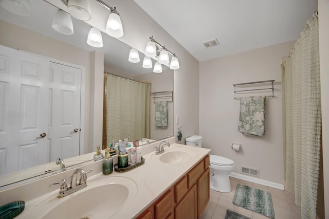 0N745 Bartelt Rd, Geneva, IL 60134 - bathroom featuring toilet, tile patterned floors, baseboards, and double vanity