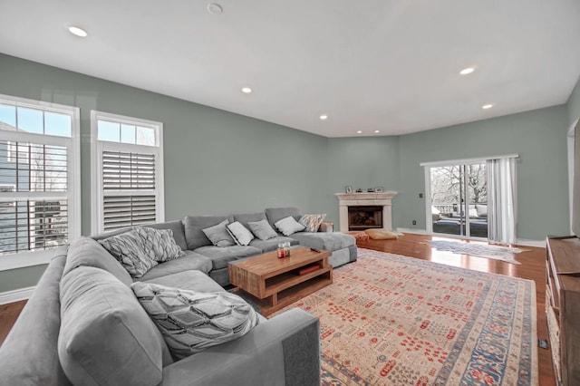 0N745 Bartelt Rd, Geneva, IL 60134 - living room featuring wood finished floors, recessed lighting, a fireplace with raised hearth, and baseboards