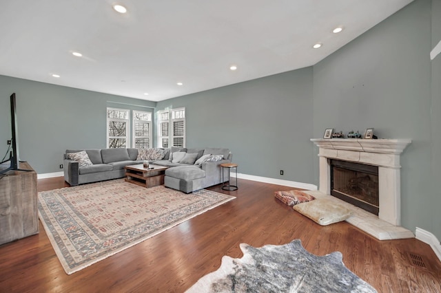0N745 Bartelt Rd, Geneva, IL 60134 - living room with a fireplace with raised hearth, baseboards, recessed lighting, and wood finished floors