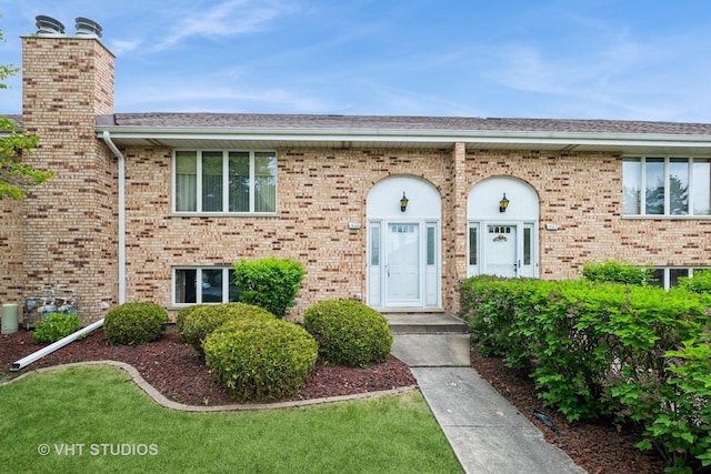 15309 S 73rd Ave Unit 15309, Orland Park, IL 60462 - view of front of property featuring a chimney, brick siding, and roof with shingles