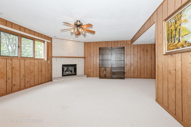 15309 S 73rd Ave Unit 15309, Orland Park, IL 60462 - unfurnished living room with wood walls, ceiling fan, a fireplace, and carpet
