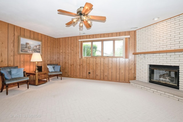 15309 S 73rd Ave Unit 15309, Orland Park, IL 60462 - sitting room with carpet flooring, a fireplace, wooden walls, and a ceiling fan