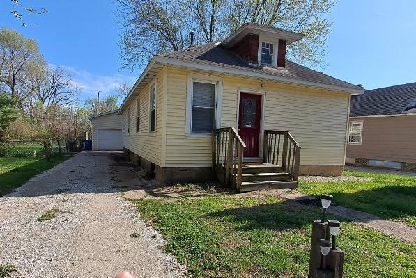 443 E St, Depue, IL 61322 - view of front of home with an outbuilding, a front yard, a garage, and crawl space