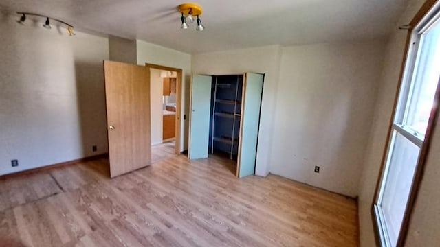 443 E St, Depue, IL 61322 - unfurnished bedroom with wood finished floors and multiple windows