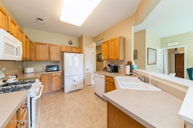 2507 Rolling Rdg, Elgin, IL 60124 - kitchen with white appliances, a sink, light countertops, a peninsula, and light flooring