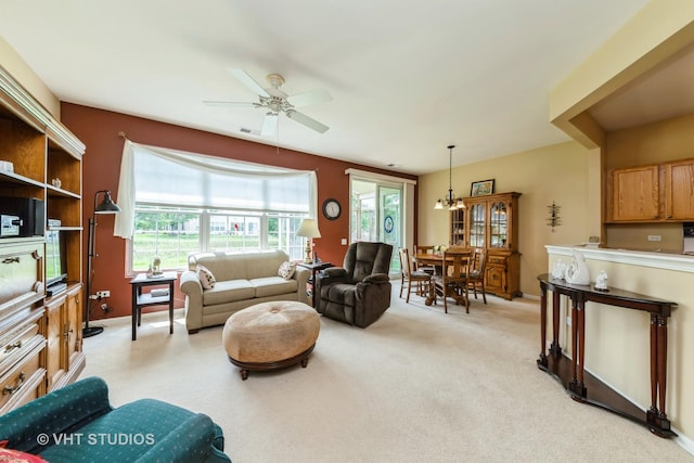 2507 Rolling Rdg, Elgin, IL 60124 - living area featuring a ceiling fan, light carpet, a chandelier, and baseboards