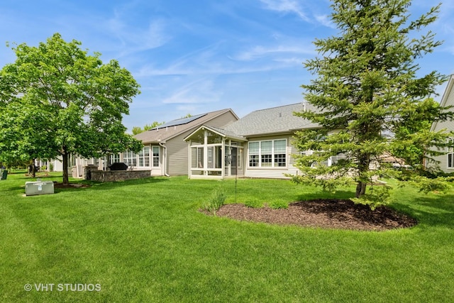 2507 Rolling Rdg, Elgin, IL 60124 - rear view of house featuring a sunroom, a yard, solar panels, and roof with shingles