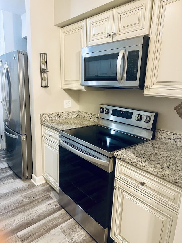 1381 N Glen Cir Unit D, Aurora, IL 60506 - kitchen with stainless steel appliances, light wood finished floors, and light stone countertops