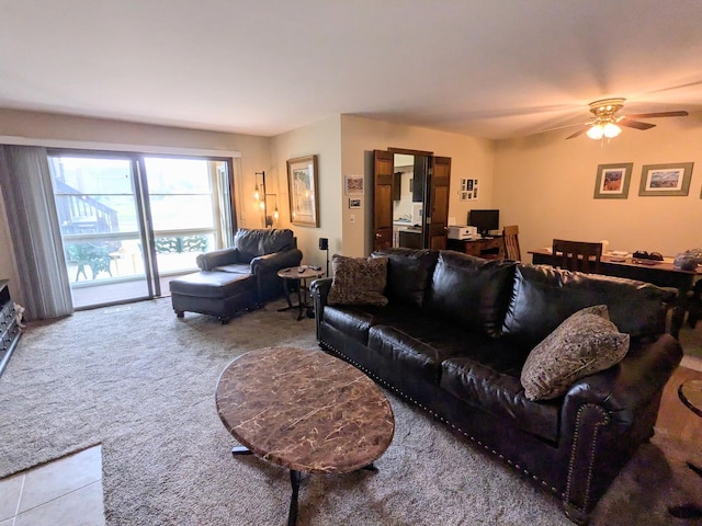 carpeted living room featuring ceiling fan
