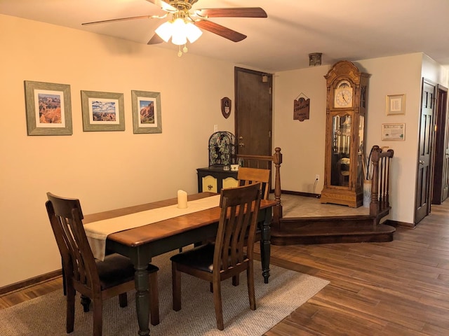 dining area with a ceiling fan, wood finished floors, and baseboards
