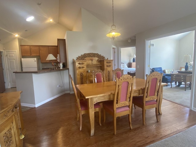 2018 Olmstead Dr Unit 2018, Woodstock, IL 60098 - dining area featuring lofted ceiling and dark wood-type flooring