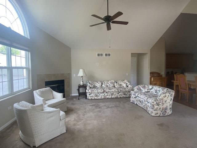 2018 Olmstead Dr Unit 2018, Woodstock, IL 60098 - carpeted living room with high vaulted ceiling, ceiling fan, and a tiled fireplace