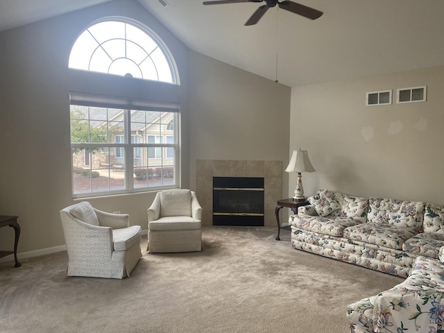 2018 Olmstead Dr Unit 2018, Woodstock, IL 60098 - living room featuring carpet flooring, vaulted ceiling, a ceiling fan, and a tile fireplace