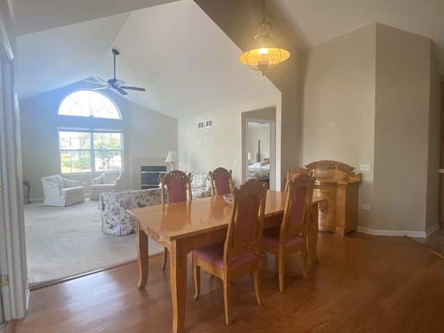 2018 Olmstead Dr Unit 2018, Woodstock, IL 60098 - dining room with lofted ceiling, wood finished floors, ceiling fan, and a tiled fireplace