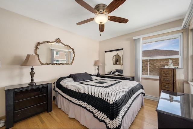 4522 N Reserve Ave, Chicago, IL 60656 - bedroom with light wood-type flooring, baseboards, and ceiling fan