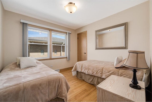 4522 N Reserve Ave, Chicago, IL 60656 - bedroom with light wood-type flooring, baseboards, and baseboard heating