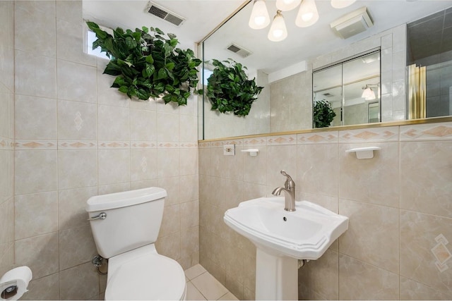 4522 N Reserve Ave, Chicago, IL 60656 - bathroom with tile walls, toilet, a chandelier, and a sink