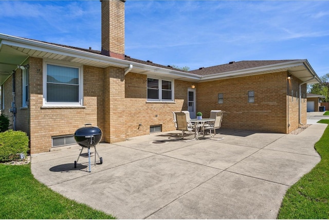 4522 N Reserve Ave, Chicago, IL 60656 - back of house with brick siding, a patio area, a chimney, and outdoor dining space