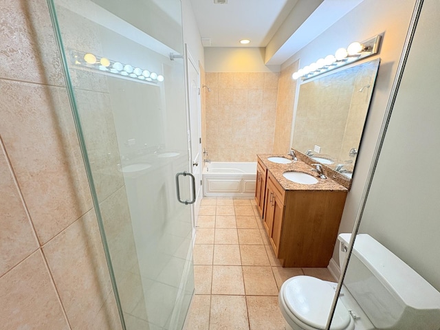 25 E 26th St Unit 2, Chicago, IL 60616 - full bathroom featuring tile patterned flooring, toilet, a bath, a stall shower, and double vanity