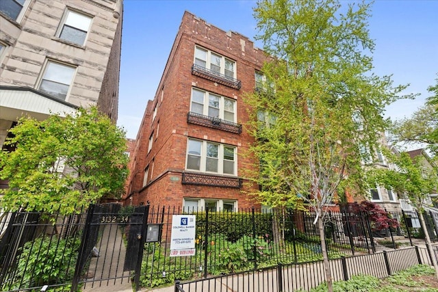 view of building exterior with a fenced front yard