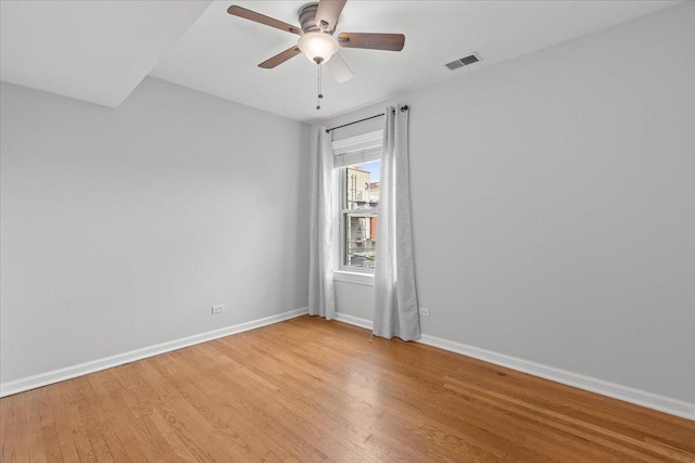 unfurnished room with light wood-style flooring, baseboards, and a ceiling fan