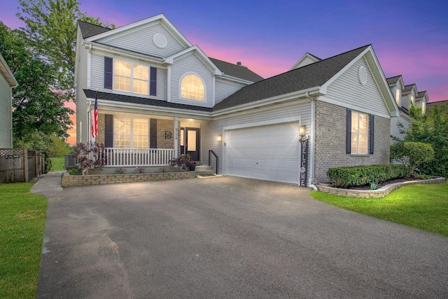 3174 Larrabee Dr, Geneva, IL 60134 - traditional-style house featuring asphalt driveway, a porch, brick siding, and an attached garage