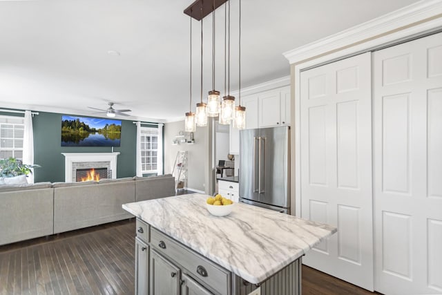 3174 Larrabee Dr, Geneva, IL 60134 - kitchen with high quality fridge, ceiling fan, dark wood finished floors, a warm lit fireplace, and hanging light fixtures
