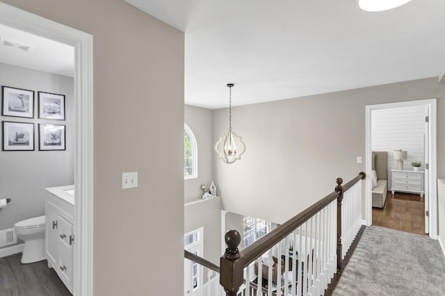 3174 Larrabee Dr, Geneva, IL 60134 - hall featuring an upstairs landing, dark wood-style floors, a chandelier, and baseboards
