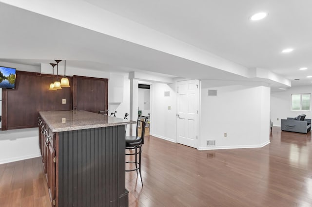 3174 Larrabee Dr, Geneva, IL 60134 - kitchen with recessed lighting, dark wood-style floors, baseboards, a breakfast bar, and open floor plan