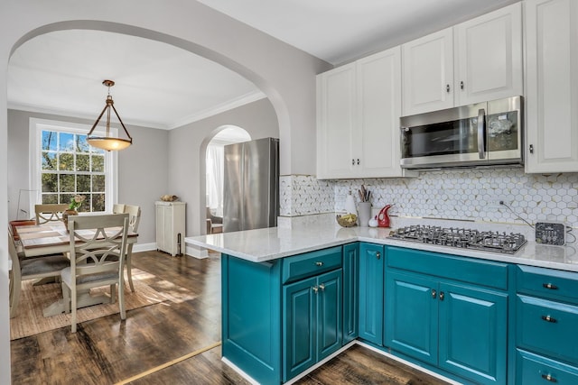 1217 Hull Ter Unit 2A, Evanston, IL 60202 - kitchen featuring appliances with stainless steel finishes, white cabinets, crown molding, decorative backsplash, and arched walkways