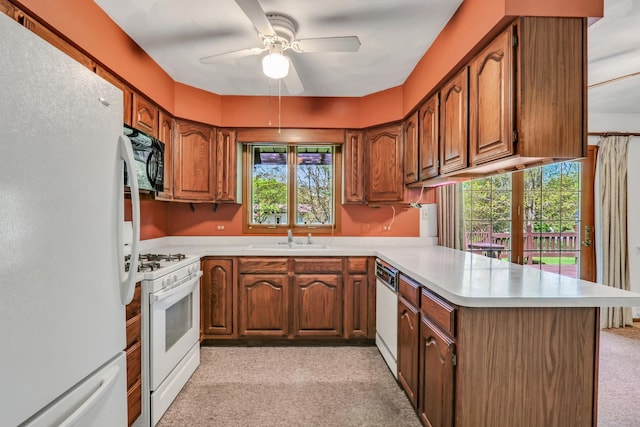10762 W Talmadge Ave, Beach Park, IL 60099 - kitchen with white appliances, a peninsula, light carpet, a sink, and light countertops