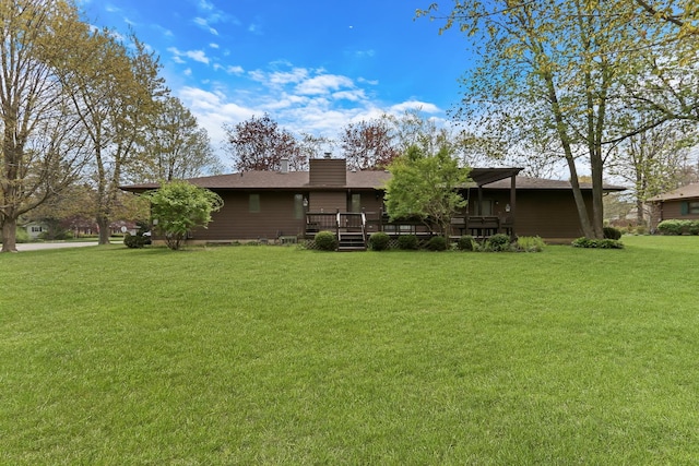 10762 W Talmadge Ave, Beach Park, IL 60099 - back of property with a deck, a yard, and a chimney