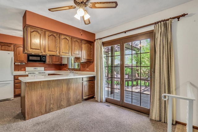 10762 W Talmadge Ave, Beach Park, IL 60099 - kitchen featuring white appliances, brown cabinetry, a peninsula, and light countertops