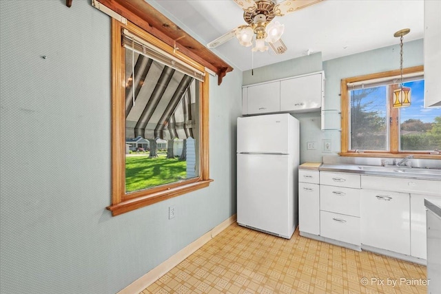 1029 S 5th St, Saint Charles, IL 60174 - kitchen featuring freestanding refrigerator, a sink, white cabinetry, a ceiling fan, and light floors